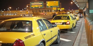 taxis lined up at airport curb