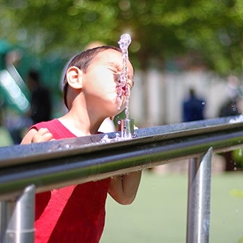 Boy Drinks from Water Fountain