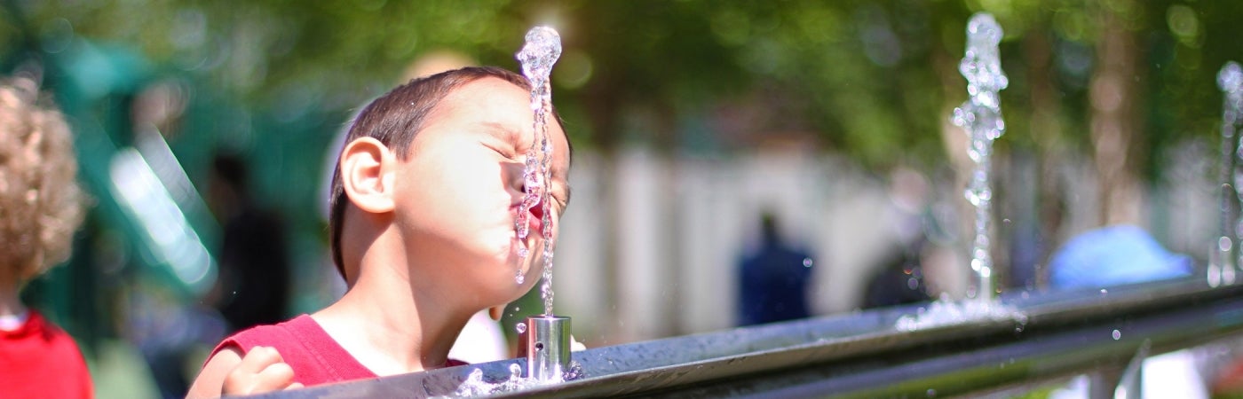 Boy drinking from water foutain