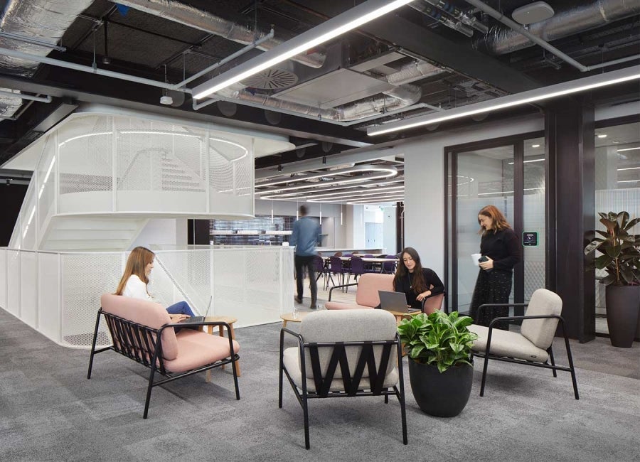 Workers in an open-plan office at One Braham, London, UK.