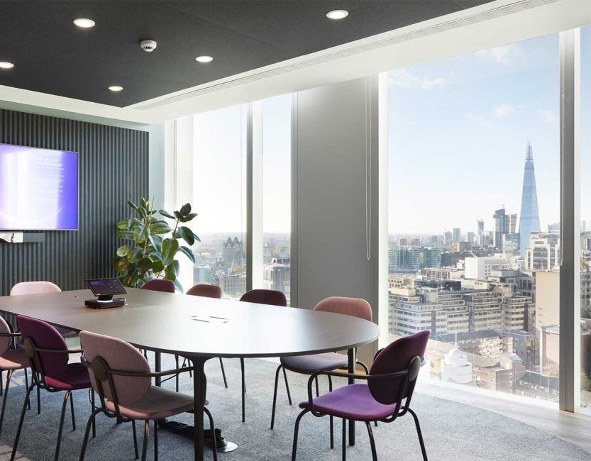 Desk in meeting room at One Braham, London, UK. The shard and the London skyline can be seen from the window.