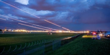 timelapse of planes taking off into evening from airport