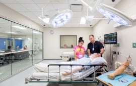 students learning in a patient room simulation