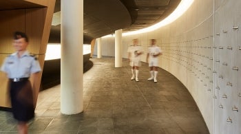 Building interior with male and female military personnel in uniform