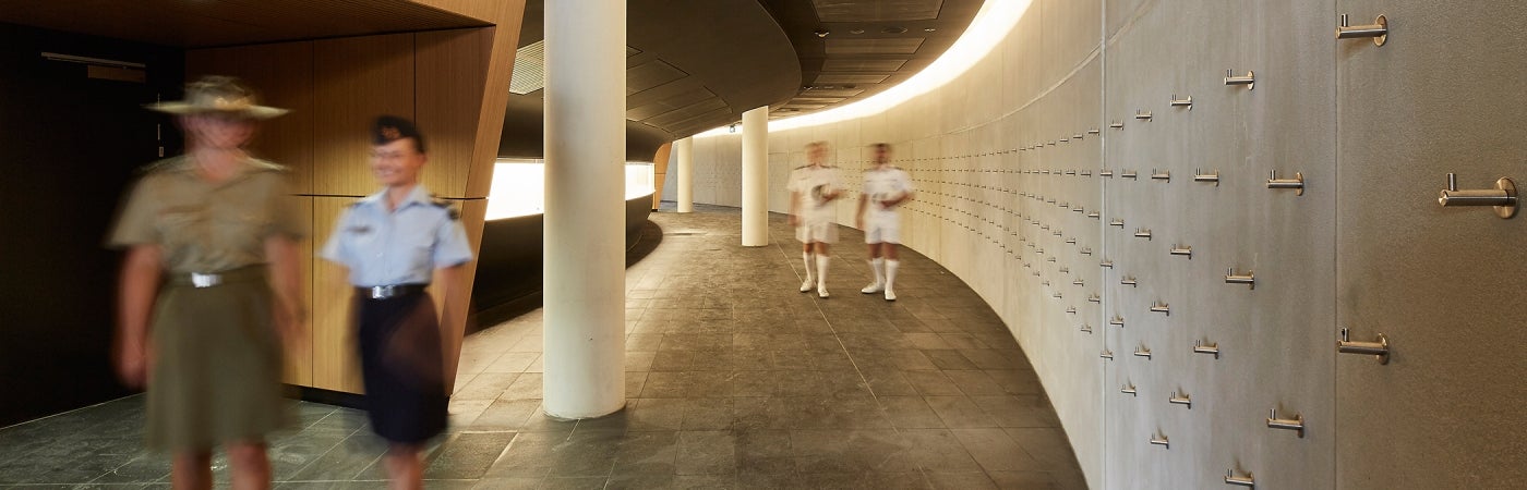 Building interior with male and female military personnel in uniform