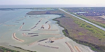 Aerial view of marsh complex and breakwater at Dollar Bay Marsh in Galveston, Texas.