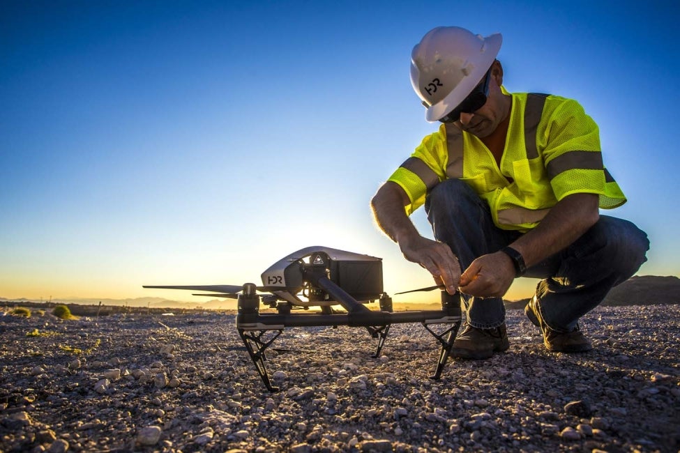 man and drone on land