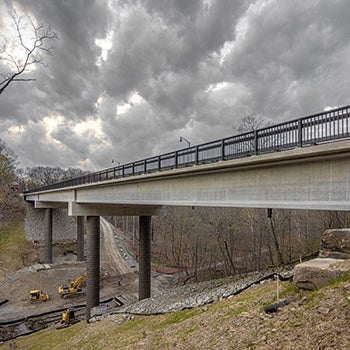 Completed Fern Hollow bridge with clouds behind