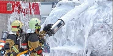 firefighters spraying flames