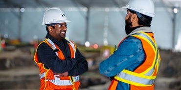 Two men talking at a construction site