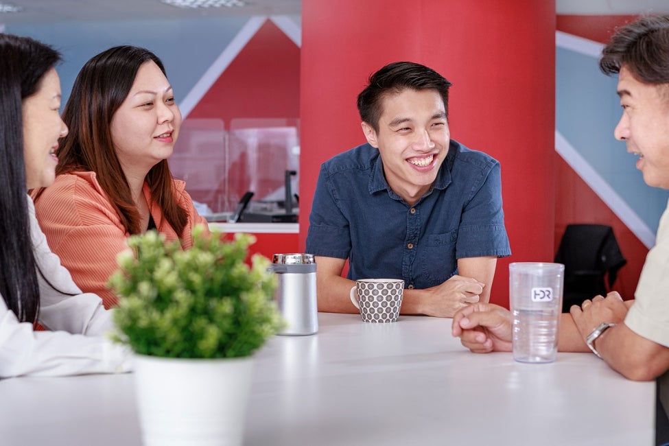 Employees chat in HDR's Singapore-office