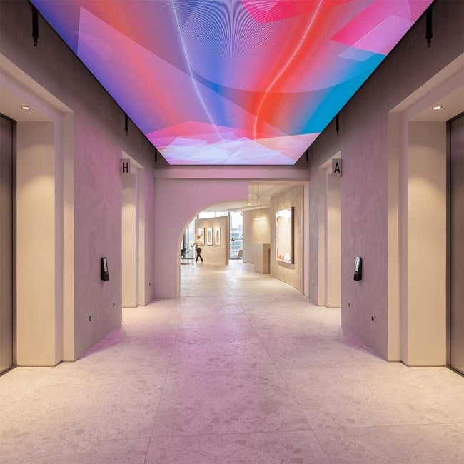 Interior of 22 Bishopsgate, London. Hallway with digital display fixed to ceiling. 