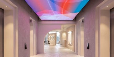 Interior of 22 Bishopsgate, London. Hallway with digital display fixed to ceiling. 