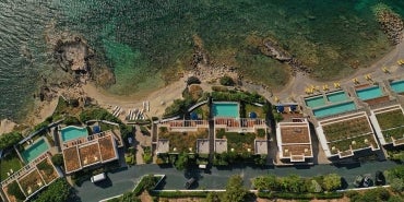 An overhead shot of a hotel resort close to the seashore.