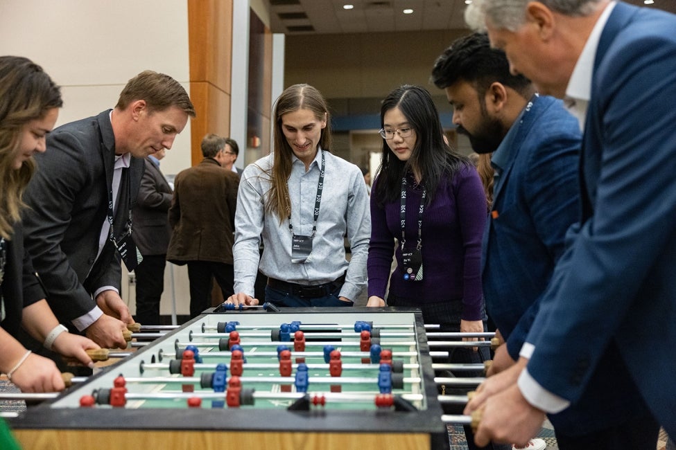 Employees playing foosball