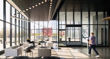 professional photograph of lobby interior at kiewit corporations headquarters in Omaha, Nebraska. The space is surrounded by windows with ample daylight and modern furnishing.