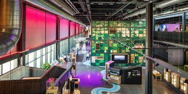 Interior view from second floor overlooking the colorful exhibit space below at the Kiewit Luminarium