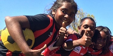 Kids pose in their football uniforms