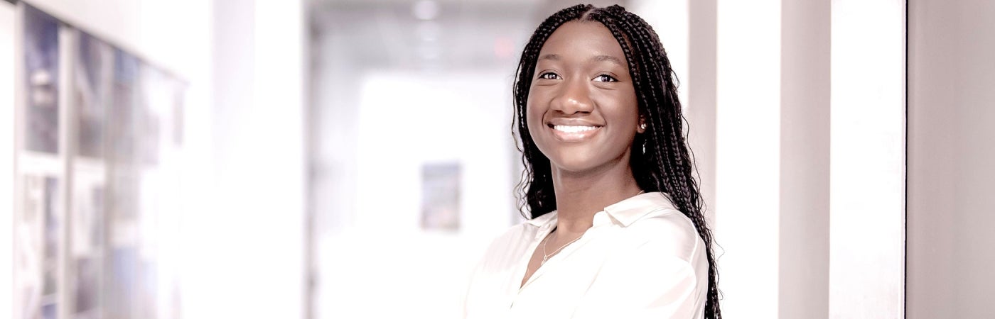 An HDR intern poses in an office