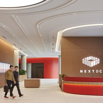 interior view of NEXTDC Merlot 2 Data Center with wood finishes and warm pops of color