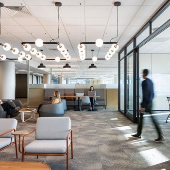 Open office space with employees working in flexible workspaces 