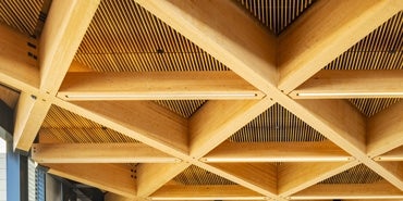 Mass timber ceiling with a geometric design and wood connections