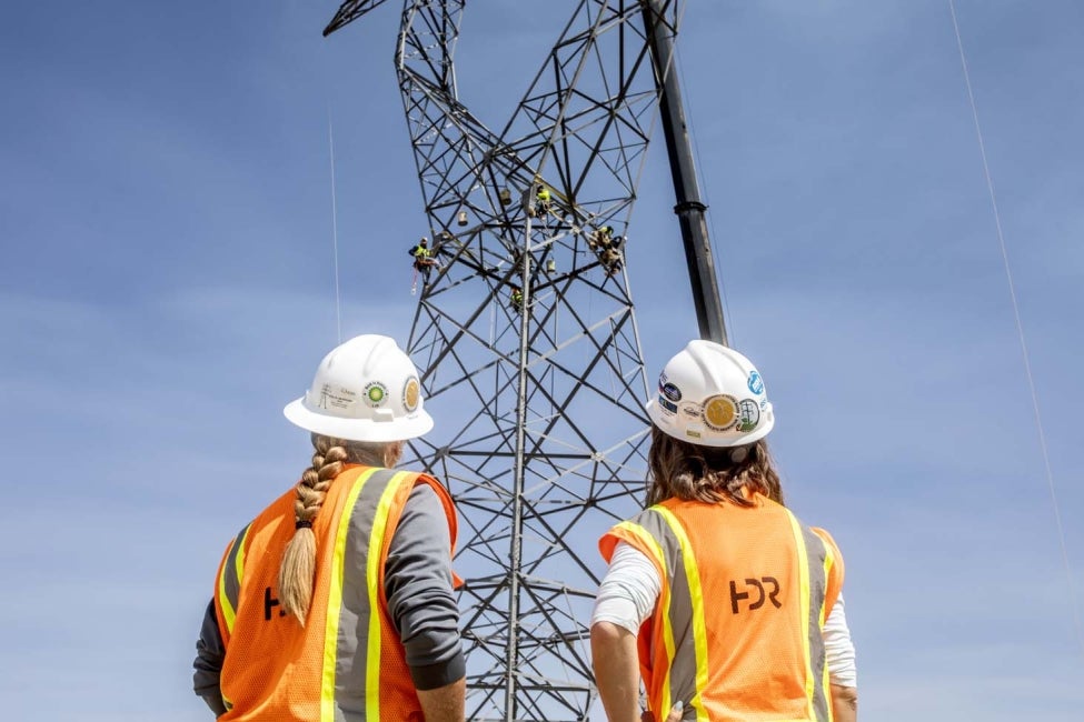 2 HDR employees at power site watching inspectors