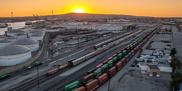 train at port of long beach with sun setting in background