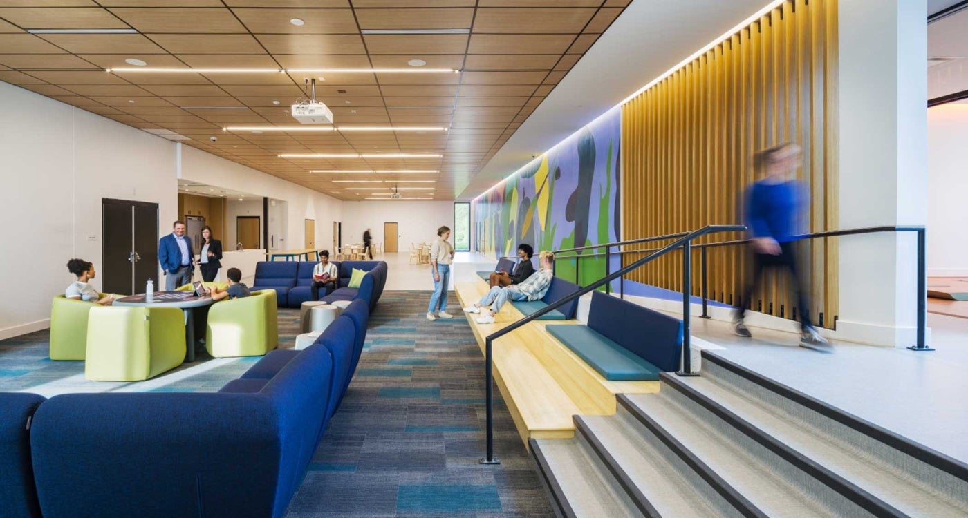 interior common room of Radius Youth Center featuring warm wood tones and bright, yet calming color accents