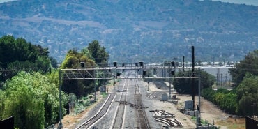 rail tracks extending into distance toward mountain