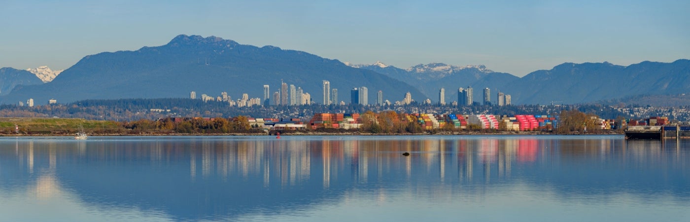 Richmond, BC city skyline with mountains in the background