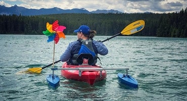 Woman enjoying water with adaptive kayak