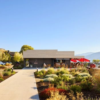 Pathway to a restaurant with outdoor seating, with lake and mountain views