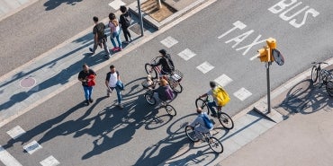 People and bicyclists in a crosswalk