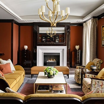 Interior of lounge area at The Beaumont Hotel, with soft furnishings and fire place in the background.