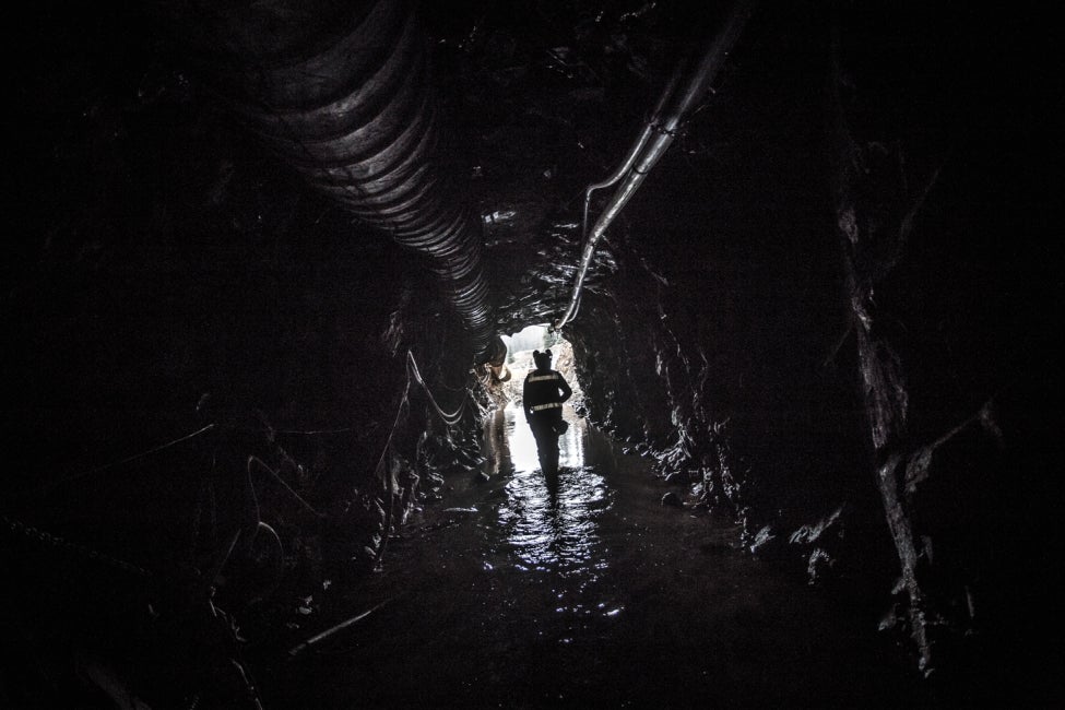 team member walking down mine shaft