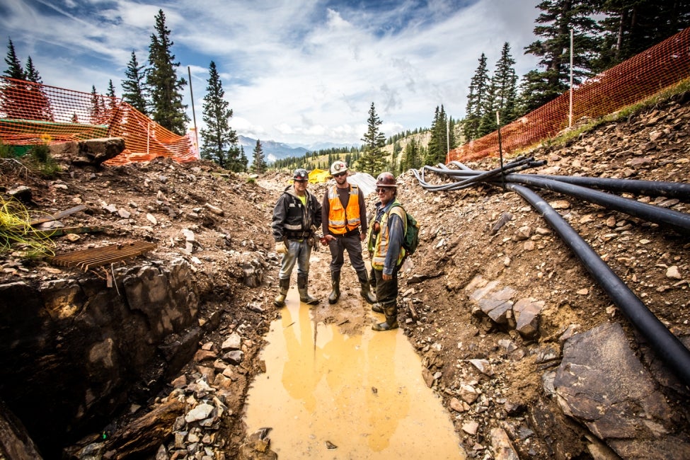 team members standing in mine opening