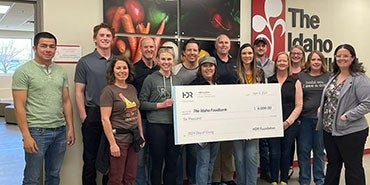 Employees from HDR's Boise office deliver a check to The Idaho Foodbank. 