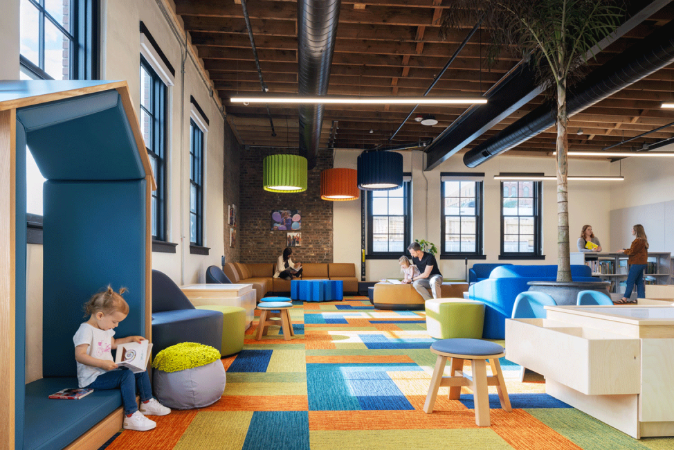 A photo of children playing in the colorful children's area at the Omaha Public Library Downtown Branch