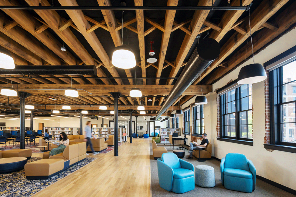 A photo of people sitting in the upstairs reading room at the Omaha Public Library Downtown Branch