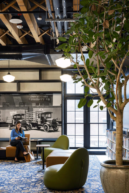 A photo of a person reading in a nook of the Omaha Public Library Downtown Branch