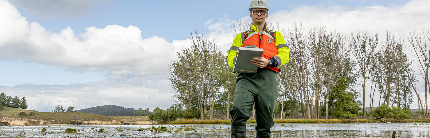 employee surveying an environmental site