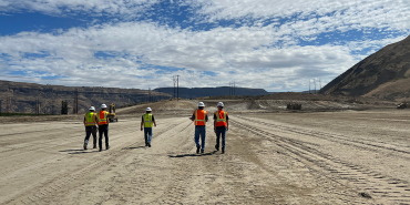 Five HDR employees walking near power transmission lines