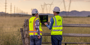 HDR employees reviewing project data at a transmission line project